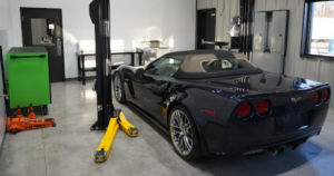 Black Corvette inside DIY garage bay with lift at Revvelation Motors in Lone Jack MO